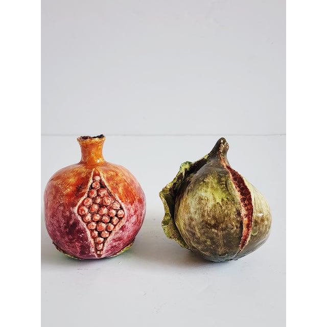 Set of two Arte Italica Italian hand made sculptural ceramic decorative fruits for table top. The 1st one represent a half...