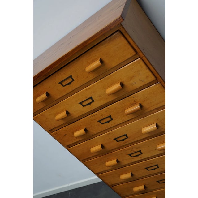 This apothecary cabinet was made circa 1950s in Germany. It features 8 drawers with wooden handles and was made from beech...