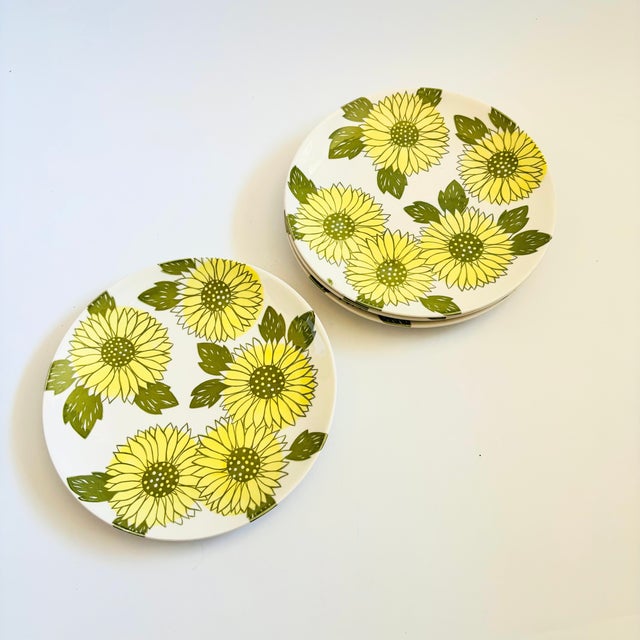 A set of 4 mid century ceramic dinner plates by Royal Ironstone in the "Sunshine" pattern. Glossy glazes with a pattern of...