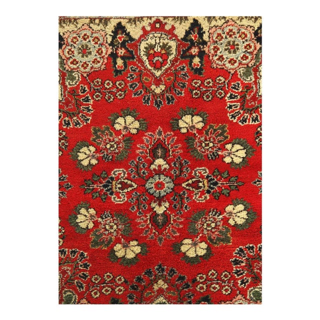 This is an antique handmade rug from the early 20th century. The piece was crafted from lamb's wool on a cotton foundation...