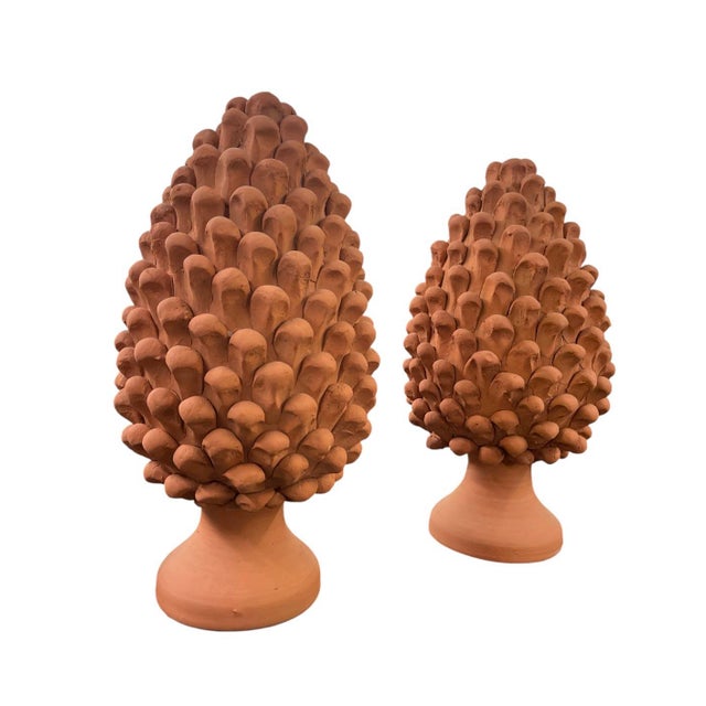 This striking pair of vintage terracotta finials features the classic pine cone motif, a timeless symbol of longevity and...
