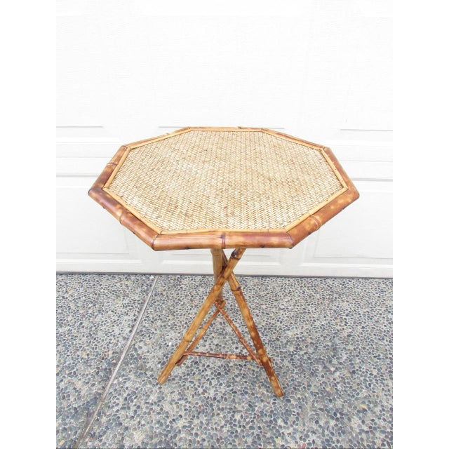 Antique English Tiger bamboo table, c.1880 Having an octagonal top with rattan, below which is a pedestal base made from...