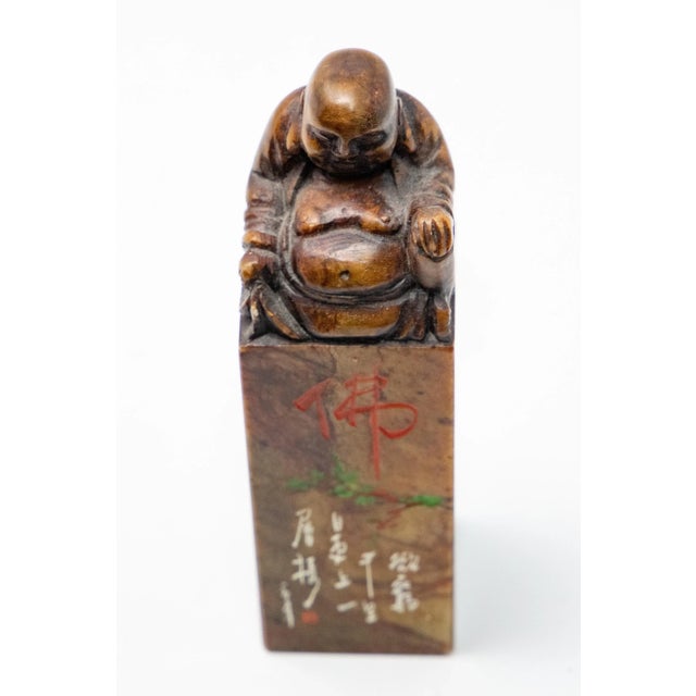 Offering a Chinese Soapstone chop seal. On top it depicts a Shoushan Laughing Buddha. Holding one hand up with palm down,...