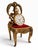 Charming miniature brass chair designed as a pocket watch display stand, featuring an elaborately pierced and scrolling...
