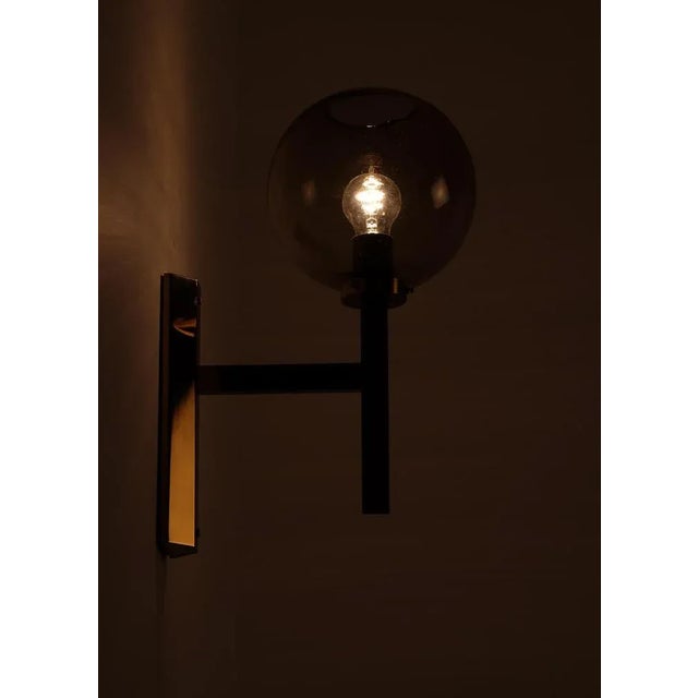 Produced in Sweden, 1970s. Smoked original glass shades and brass. This piece is attributed to the mentioned...