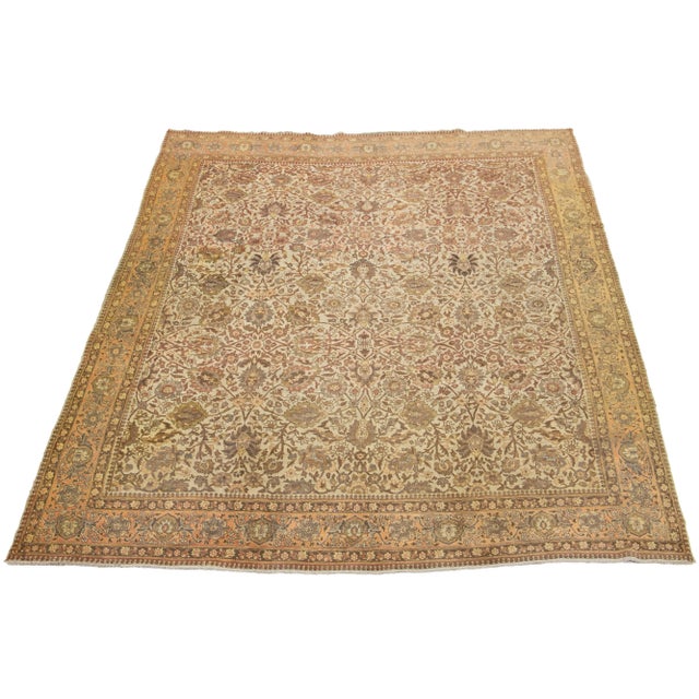 This beautifully handcrafted Persian Tabriz wool rug displays a classic all-over floral pattern. The beige background...