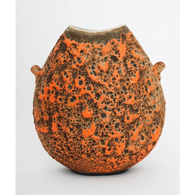 Two Ceramic Vessels, comprising: Oscar Bucher (American, b. 1931) "Lava Vessel" with red stain and two handles, signed to...