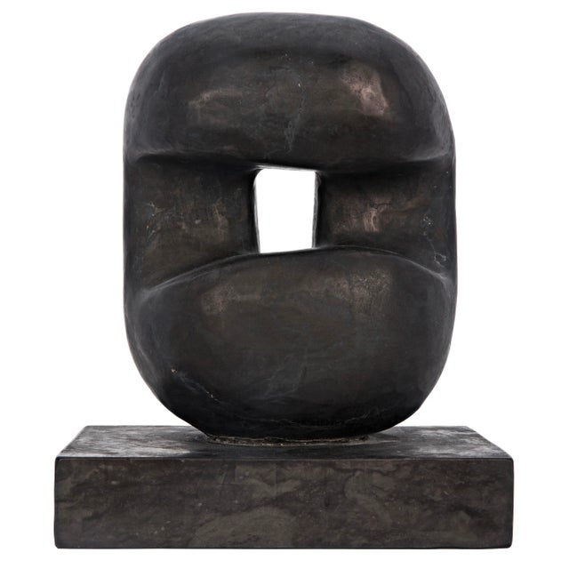 Solid marble is carved into intriguing curves in this compelling sculpture that rests on a marble base.