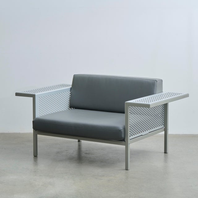Tubular steel, perforated aluminum sheet, painted stone gray (RAL 7030), upholstery, gray leather. Labeled by Maker