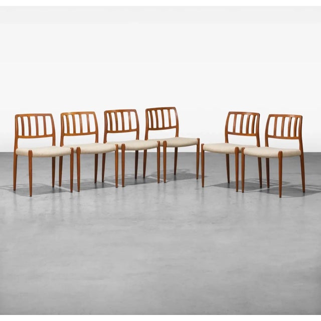 An iconic design well preserved in a completely original condition set of model 83 dining chairs in Teak and knotty wool...