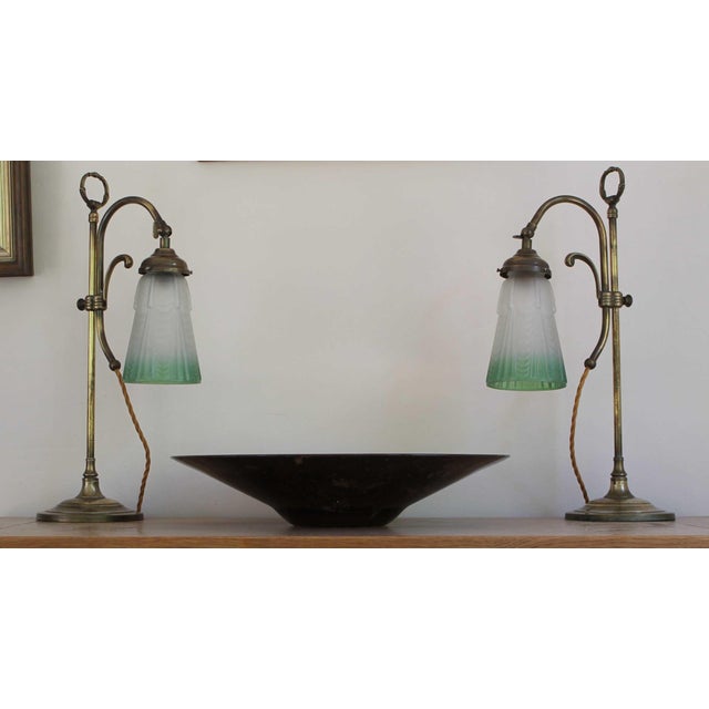 A fine pair of elegant brass table lamps having a distinctly late Victorian or early Edwardian style. Each featuring a...