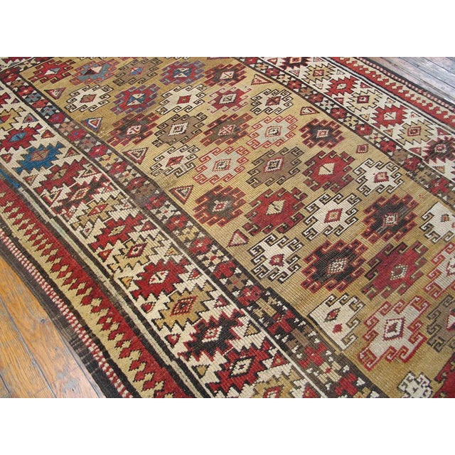 Antique Caucasian Small Scatter Size Wool Yellow Rug, Circa Date: 1930s. This exceptional piece is a vivid example of the...