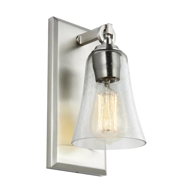 The Sean Lavin Monterro one light wall sconce in satin nickel provides abundant light for your bath vanity, while adding a...