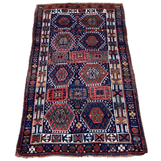 A wonderful antique Kurdish rug, handwoven circa 1900. The rug features an all over geometrical design on a deep indigo...