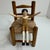 Charming mid-century wooden peg doll seated in a miniature rush-seat chair, produced by Eric Horne Co. and marked Made in...