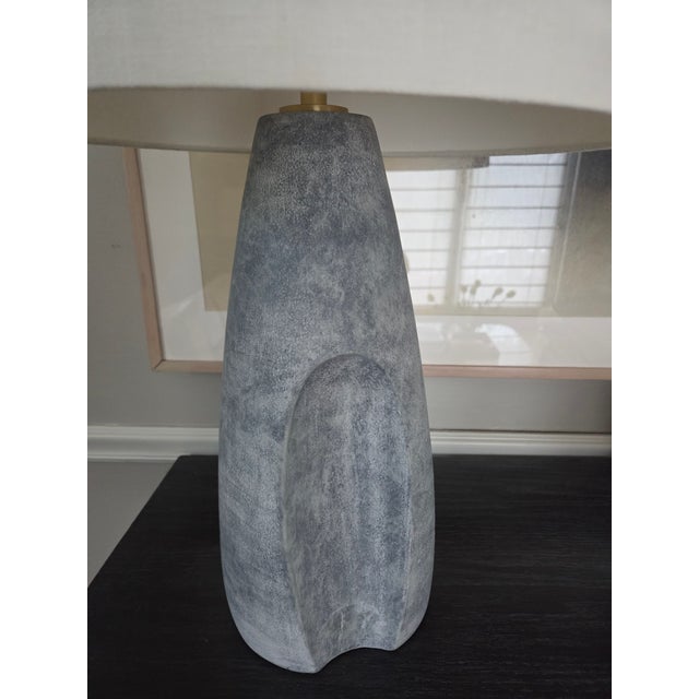 The Hackensack Table Lamp enhances any space with its unique asymmetric design and tactile glaze. This sculptural piece...