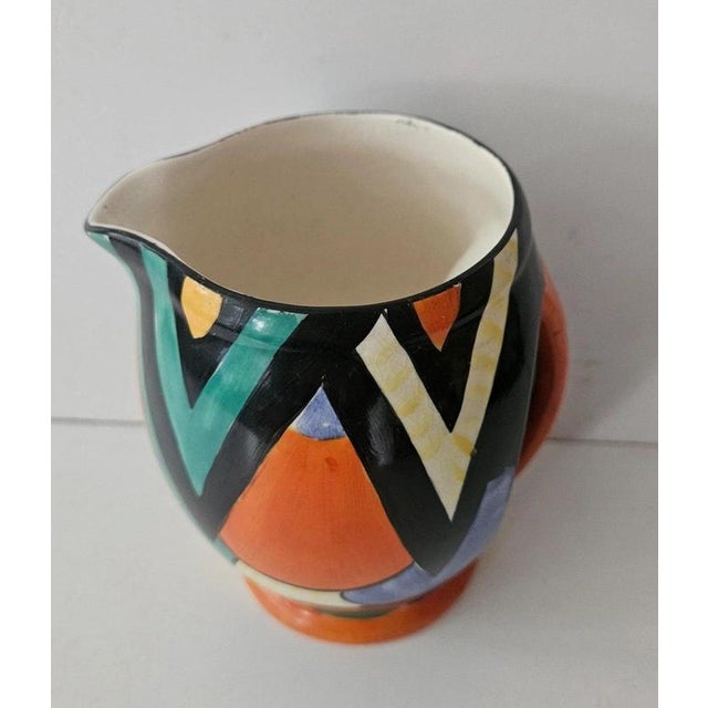 A striking Art Deco hand-painted ceramic jug designed by Enoch Boulton for Crown Devon, distinguished by its bold...