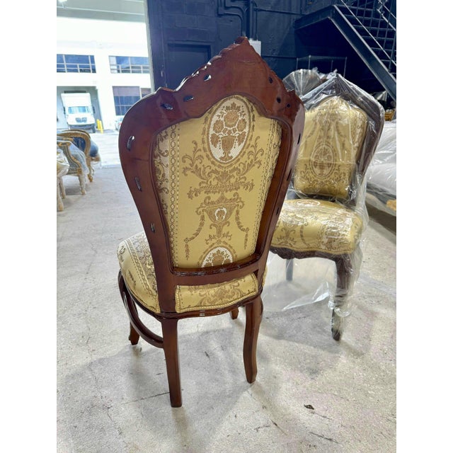 Add timeless elegance to your home with this French Rococo-style vintage chair. Featuring a hand-carved wooden frame, it...