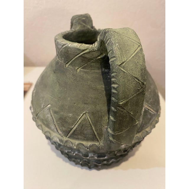 A captivating mid-century modern Brutalist terracotta amphora vase handcrafted by the noted Spanish studio, Partenon,...