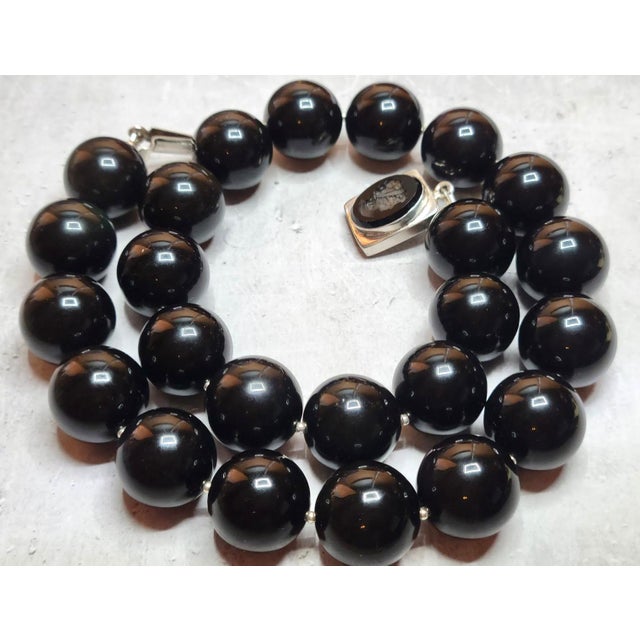 The necklace is 21 inches (53 cm) long, and the beads are 20 mm in size. Large, round obsidian beads are quite rare. The...