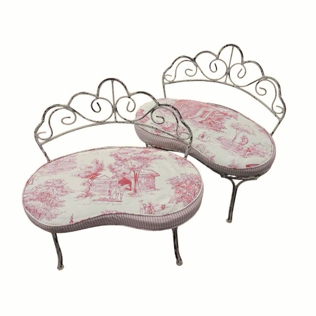 Darling pair of child-sized painted wrought iron benches in a rustic cream finish features lovely kidney shaped seats,...
