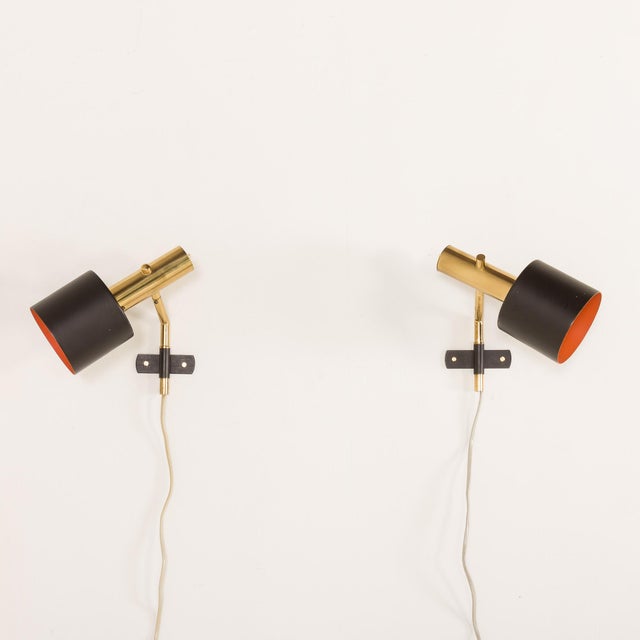A minimalist pair of wall sconces that are reminiscent of Alfa sconces by Svend Aage. Each sconce features a two-part...
