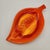Mid-century ceramic leaf-shaped ashtray in vibrant orange and yellow drip glaze with sculpted central vein detail