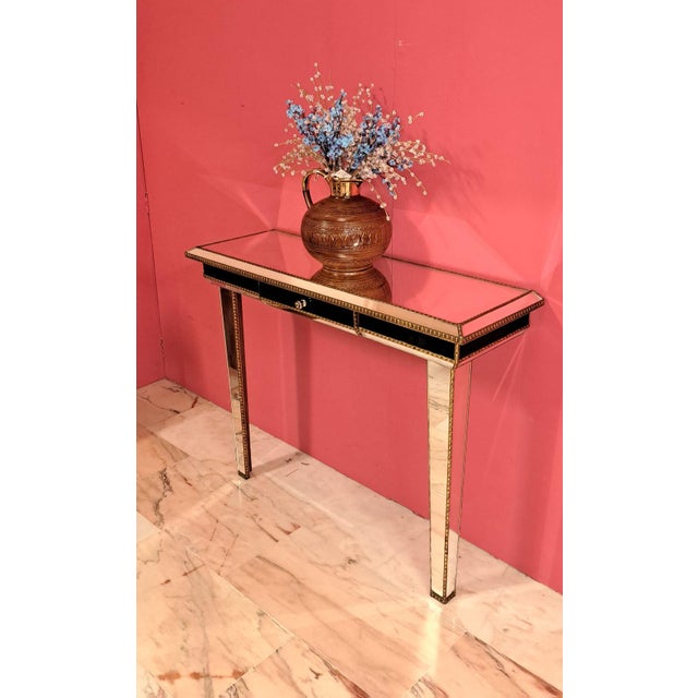 Art Deco style mirrored console table, a hall stand designed with beveled mirror panels covering both the surface and...
