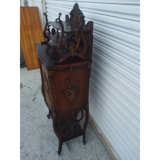 This is a stunning piece of art. This music cabinet is made of walnut and has beautiful gilted accents. The cabinet is...