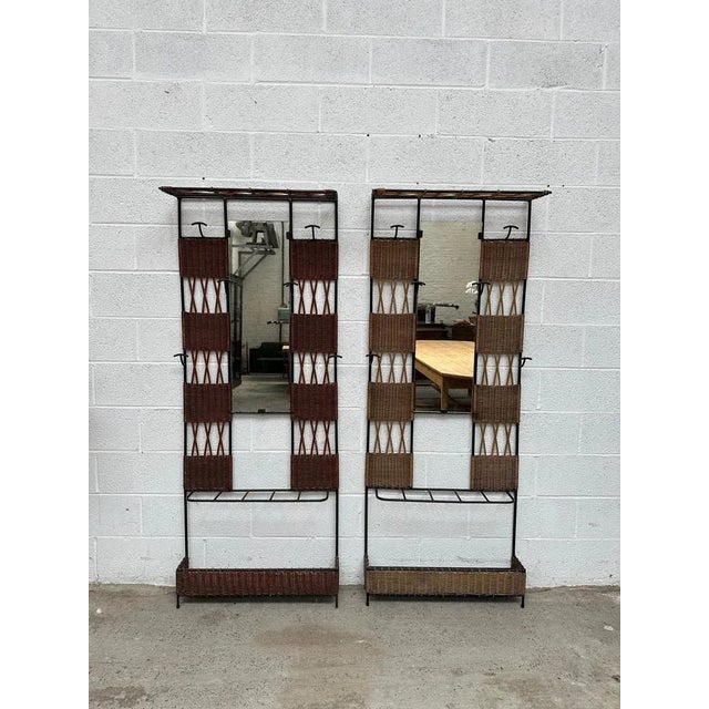 Pair of entrance checkrooms in rattan and black metal Each features 6 coat hooks, a hat rack, an umbrella stand and a...