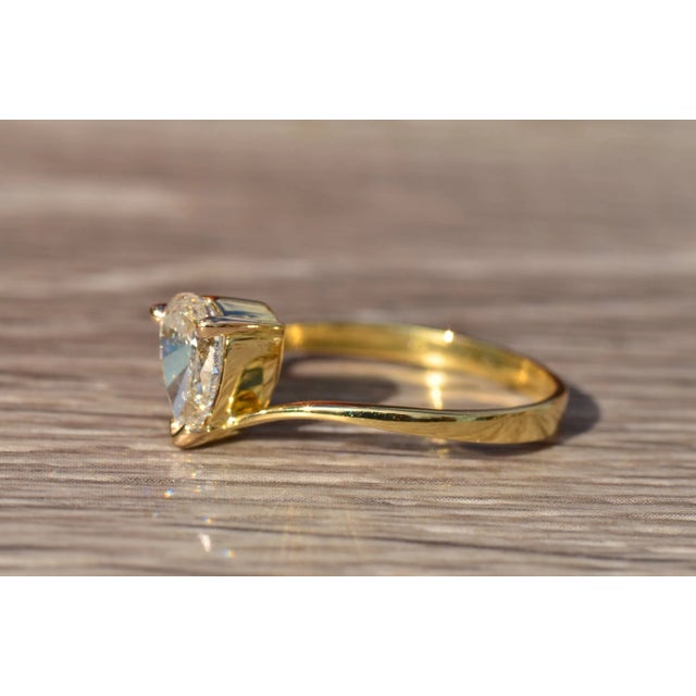 The Piore 18 Karat Yellow Gold Custom Modified Modern Bypass Diamond Ring. This contemporary ring features a 0.94 carat...