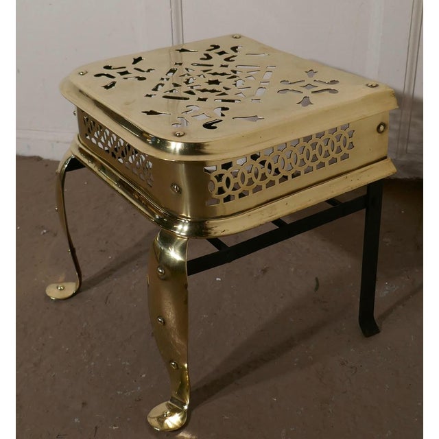 A large sturdy Georgian footman, Kettle Trivet. A large brass footman, with beautiful pierced decoration, the footman...