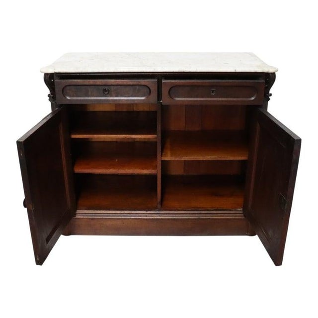 This antique Renaissance Revival sideboard, dating to approximately 1880, features a robust construction of carved walnut....