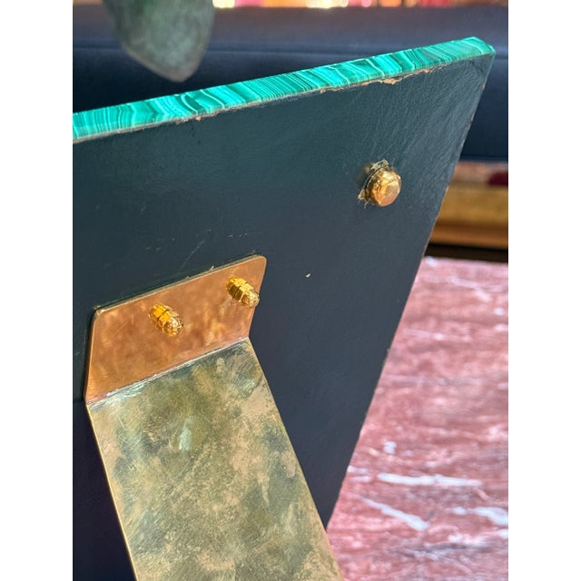 Elegant Italian picture frame from the 1970s, crafted with a polished malachite veneer and accented by a gilt brass...