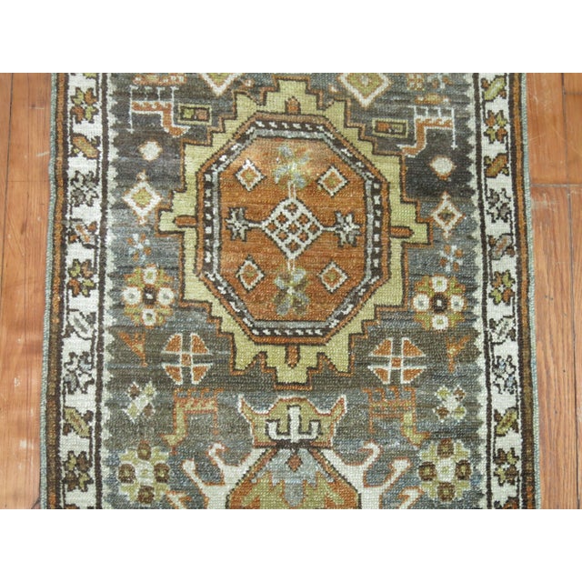 Very narrow and long one of a kind Persian Heriz runner. In greens, browns and blue predominant accents. 2'3'' x 14'2''