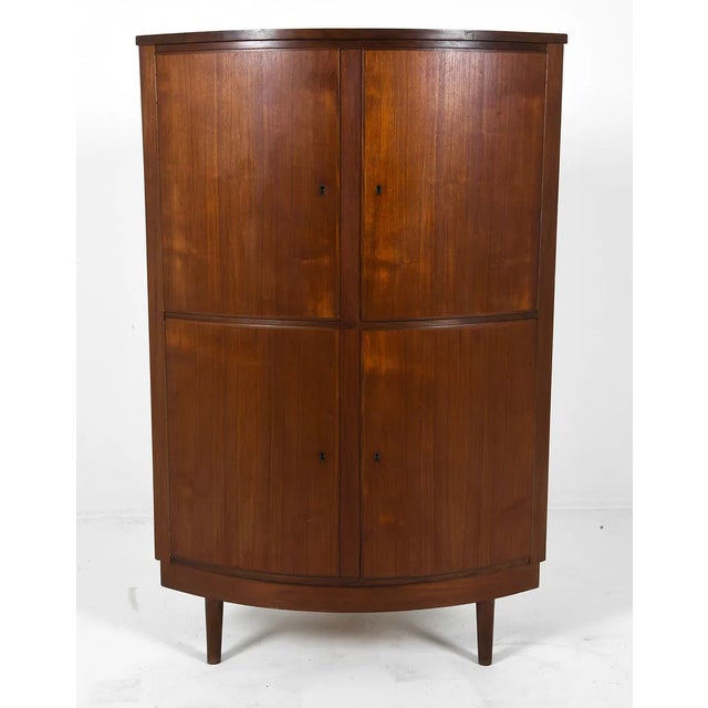 1970s Danish Corner storage cabinet with full interior shelving for display or bar use Teak veneer over case with solid...