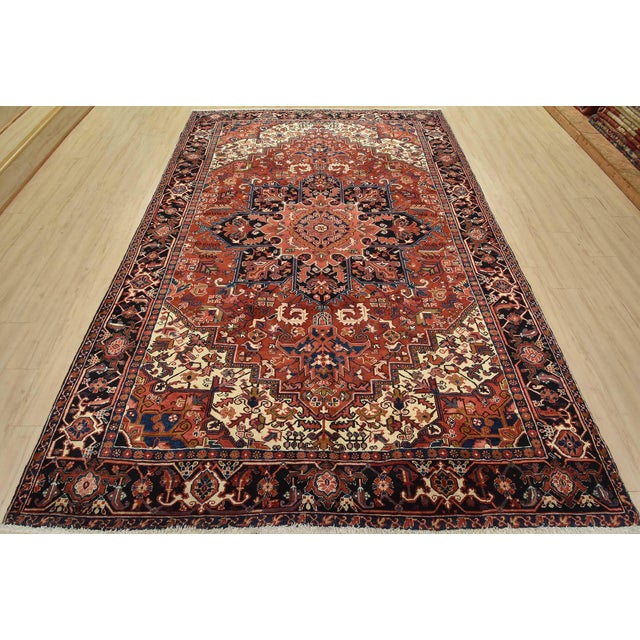 An authentic vintage traditional tribal Heriz rug hand-knotted with fine wool and natural dyes. This rug features a...