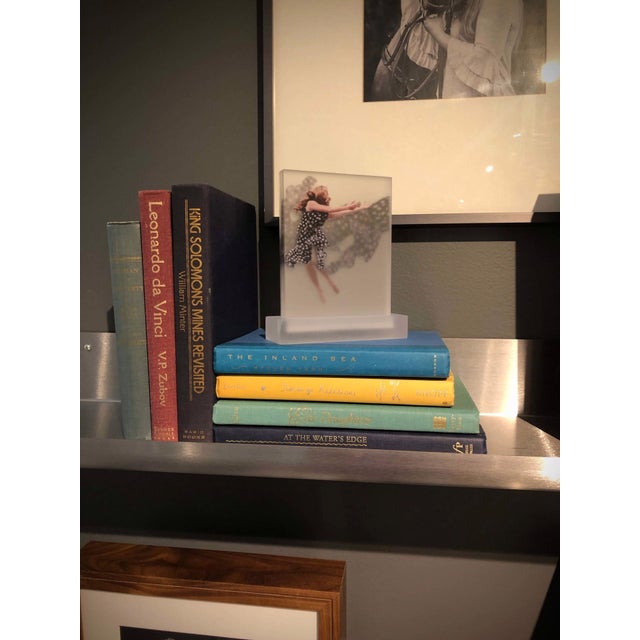 Just Out of Reach features a dynamic composition on five acrylic panels, depicting a figure in a flowing garment adorned...