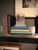 Just Out of Reach features a dynamic composition on five acrylic panels, depicting a figure in a flowing garment adorned...