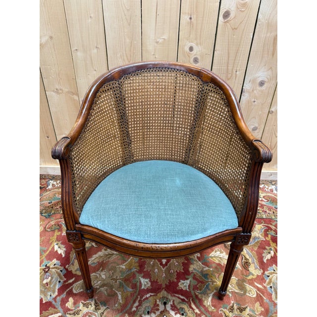 Louis XVI style caned office chair, 20th century, in mahogany-brown stained wood. The backrest is basket-shaped (barrel-...
