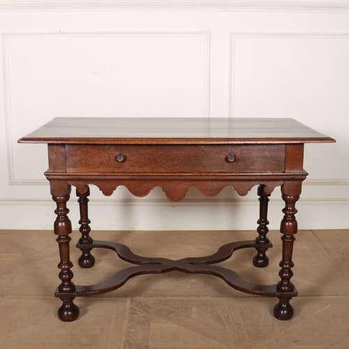 Good 18th century English oak one drawer lamp table / side table with a shaped frieze, wavy stretcher and lovely colour....