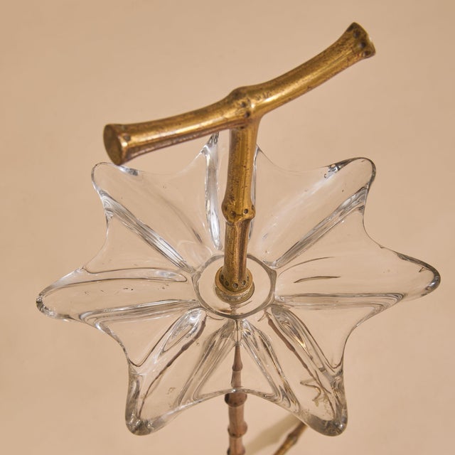 A French freestanding catchall in the manner of Maison Baguès from the 1950s, crafted in gilt bronze with a bamboo motif....