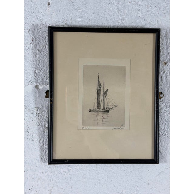 A finely detailed antique etching depicting the two-masted sailing vessel Coaster resting quietly on the water. The artist...