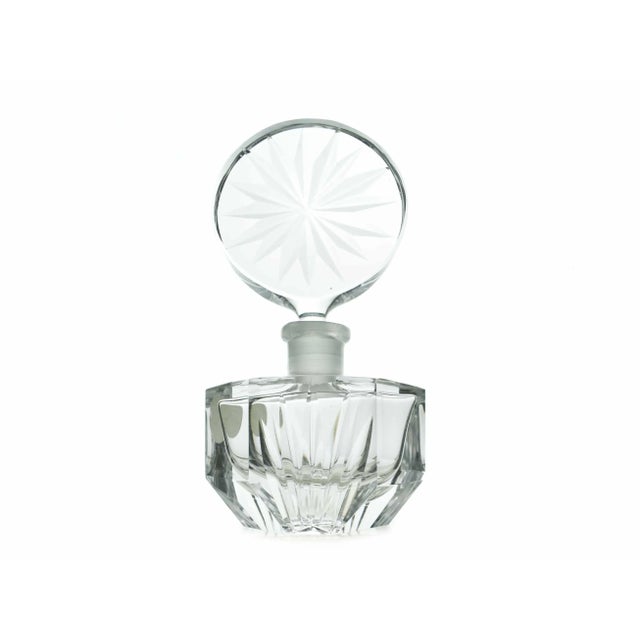 Stunning hand cut lead crystal perfume bottle with its original stopper made in West Germany. This exquisite piece graces...