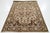 This vintage handmade wool rug has a brown and tan field with brown and blue accents all over the design. This rug...