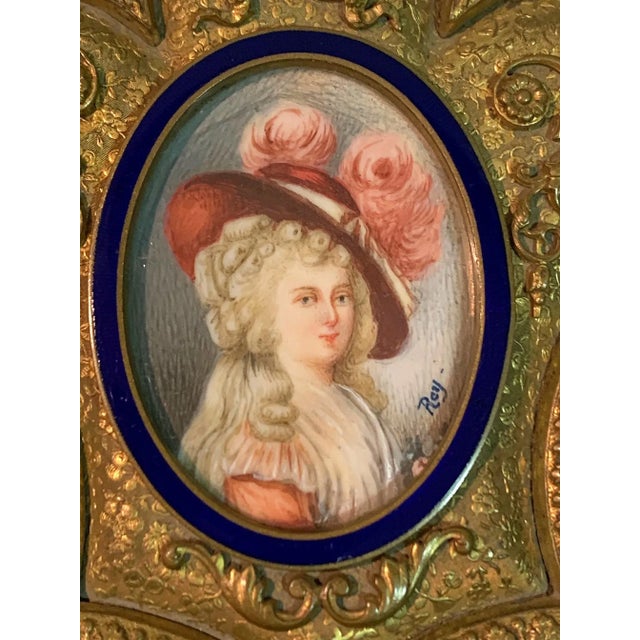 Fantastic gilded bronze box-shaped mercury fleur de lis and bordered miniature lady with blue enamel. XIX century and...