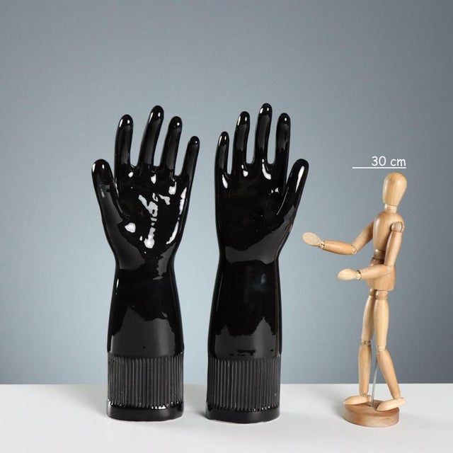 A set of six black porcelain molds for pirelli gloves. Pirelli used to make latex gloves using porcelain matrices produced...