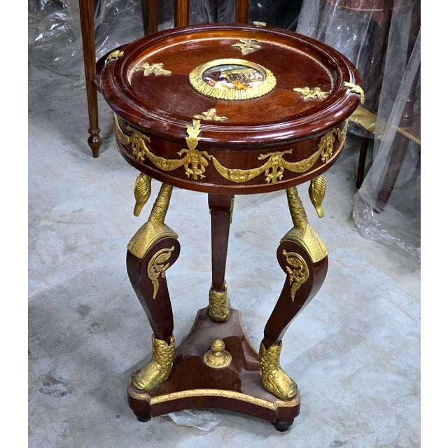 Elevate your interior with the timeless grandeur of this French Empire-inspired round side table, meticulously handcrafted...