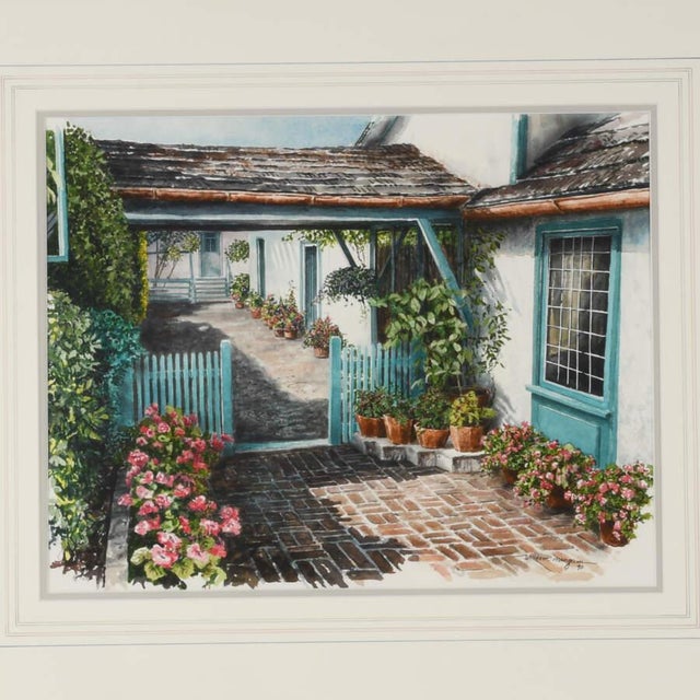 A Framed Print of William Mangum's "Gentle Breezeway" portrays a peaceful, sunlit scene featuring a charming architectural...