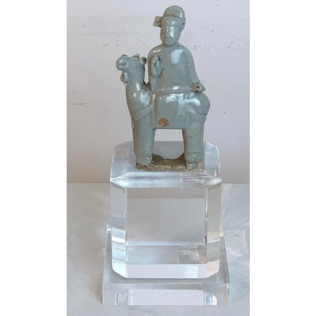 Song dynasty Chinese celadon porcelain horse and rider on later Lucite pedestal Chinese celadon porcelain horse and rider,...